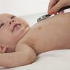 Doctors hand checking the heartbeat of a baby, close-up